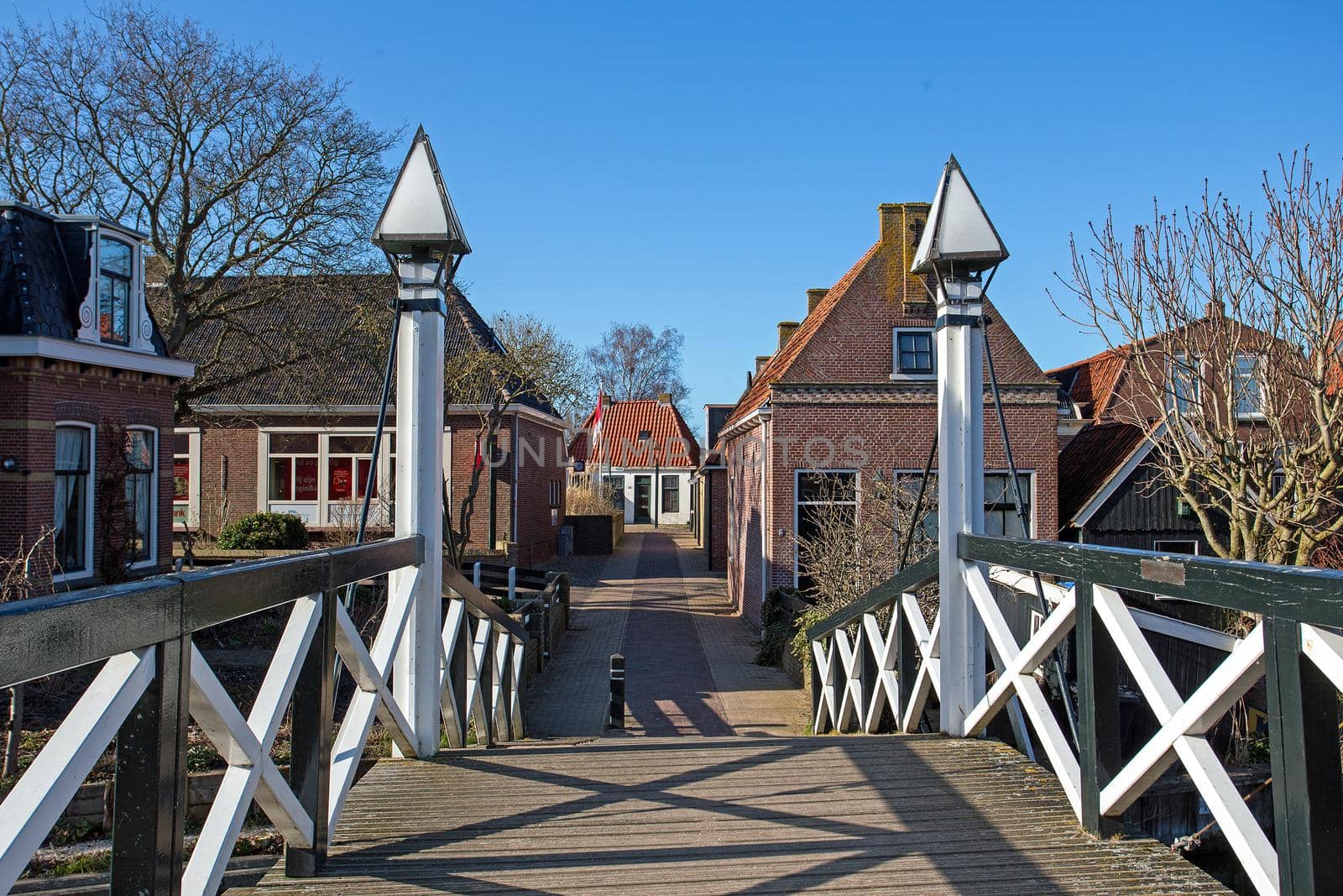 Medieval bridge and houses in the city Hindeloopen in the Netherlands by devy