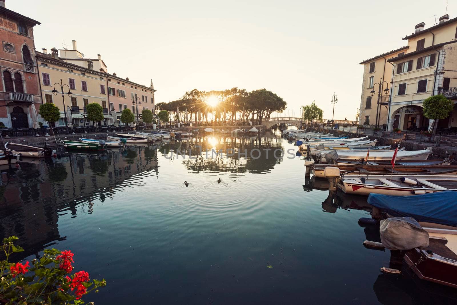 Desenzano Harbor in Desenzano del Garda at sunrise. Desenzano del Garda, Lombardy, Italy.