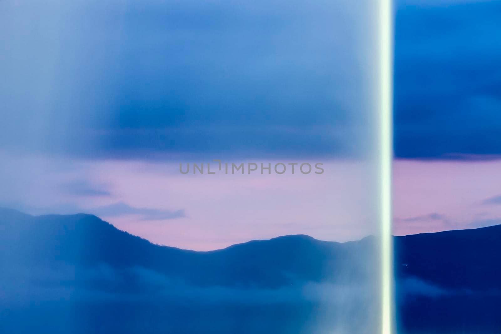 Mountains seen through Jet d'Eau in Geneva. Geneva, Switzerland.