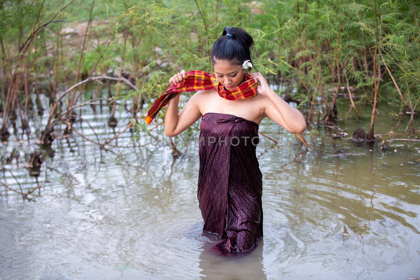 Rural Young Asian Women Bathing In A River, or Portrait Of Beautiful Young Asian Woman Bathing In The River. Asian sexy woman bathing in creek.  by chuanchai