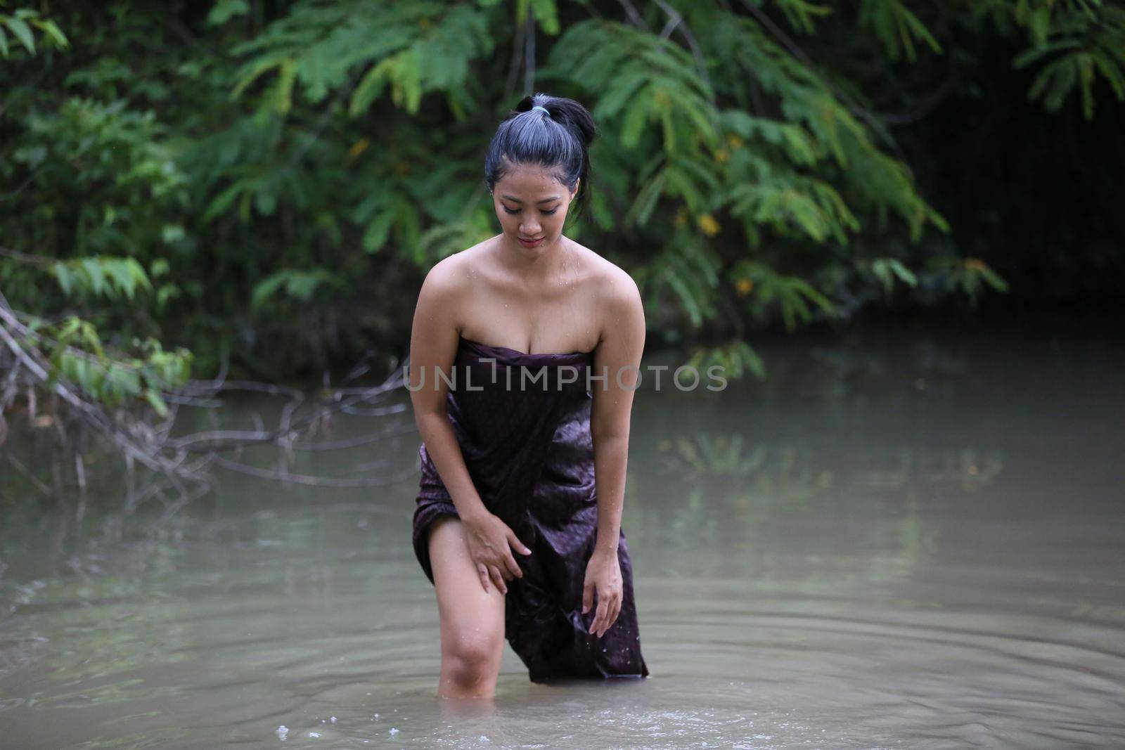 Rural Young Asian Women Bathing In A River, or Portrait Of Beautiful Young Asian Woman Bathing In The River. Asian sexy woman bathing in creek. 