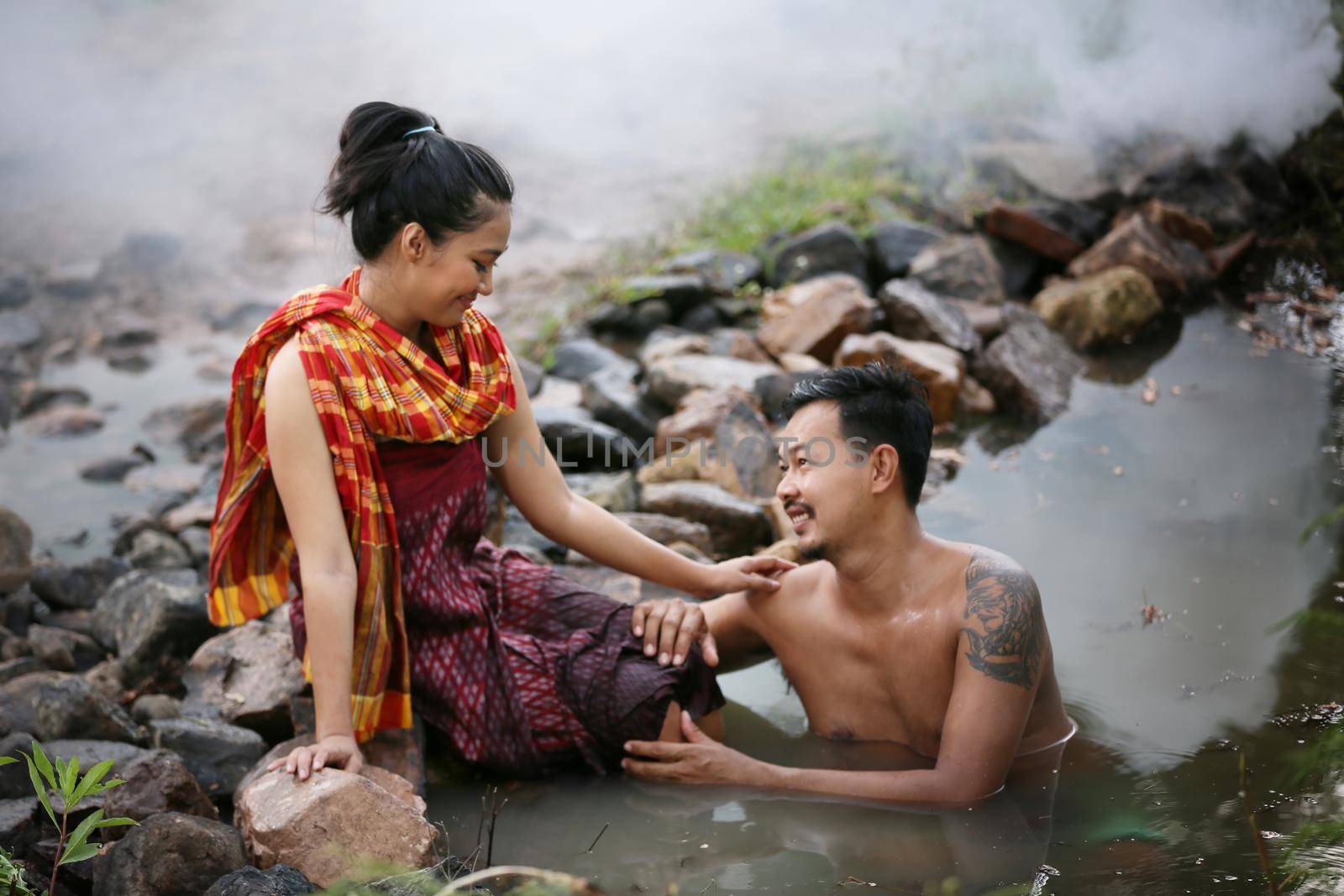 Thailand Couple love enjoy in bathing together in the river against rural background. this is life of young man and young girl couple in Countryside Thai South East Asia. by chuanchai