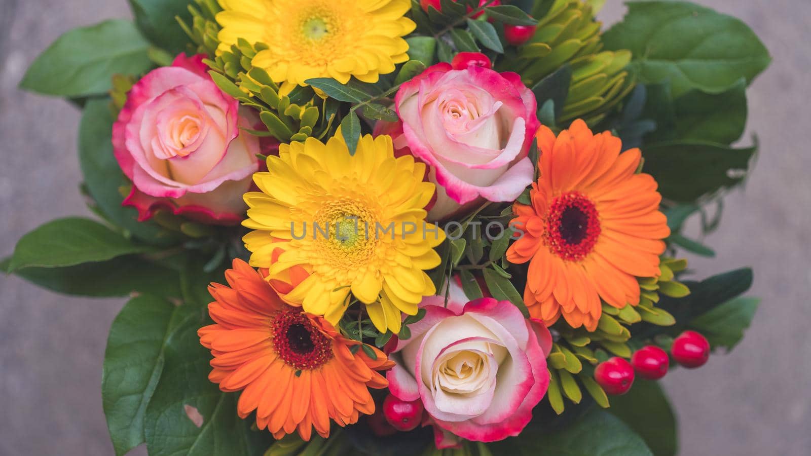 Greetings, anniversary or Mother’s Day concept: Close up of colorful fresh spring flower bouquet with gerbera and pink roses by Daxenbichler