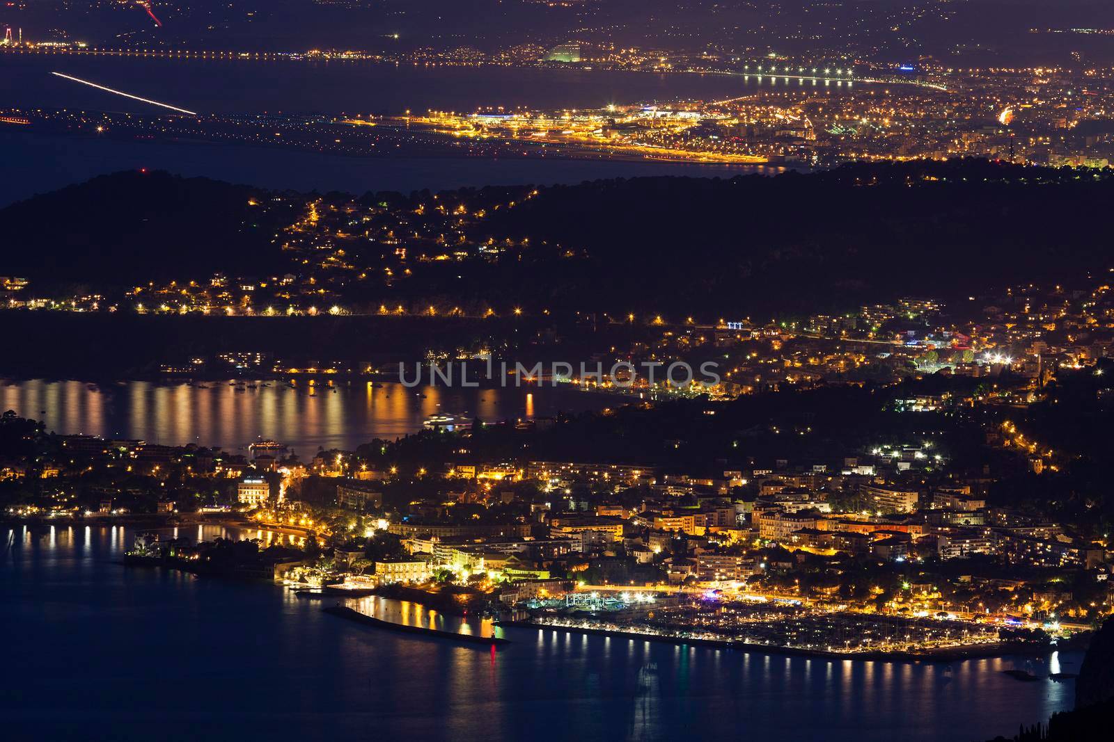Distant view of Beaulieu-sur-Mer and Nice at sunset seen from Monaco. Beaulieu-sur-Mer, French Riviera, France.