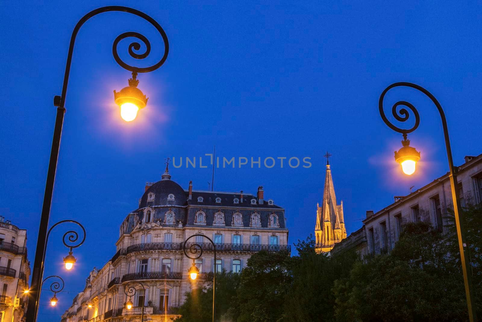 Montpellier street lamps and St. Anne Church in the background. Montpellier, Occitanie, France.