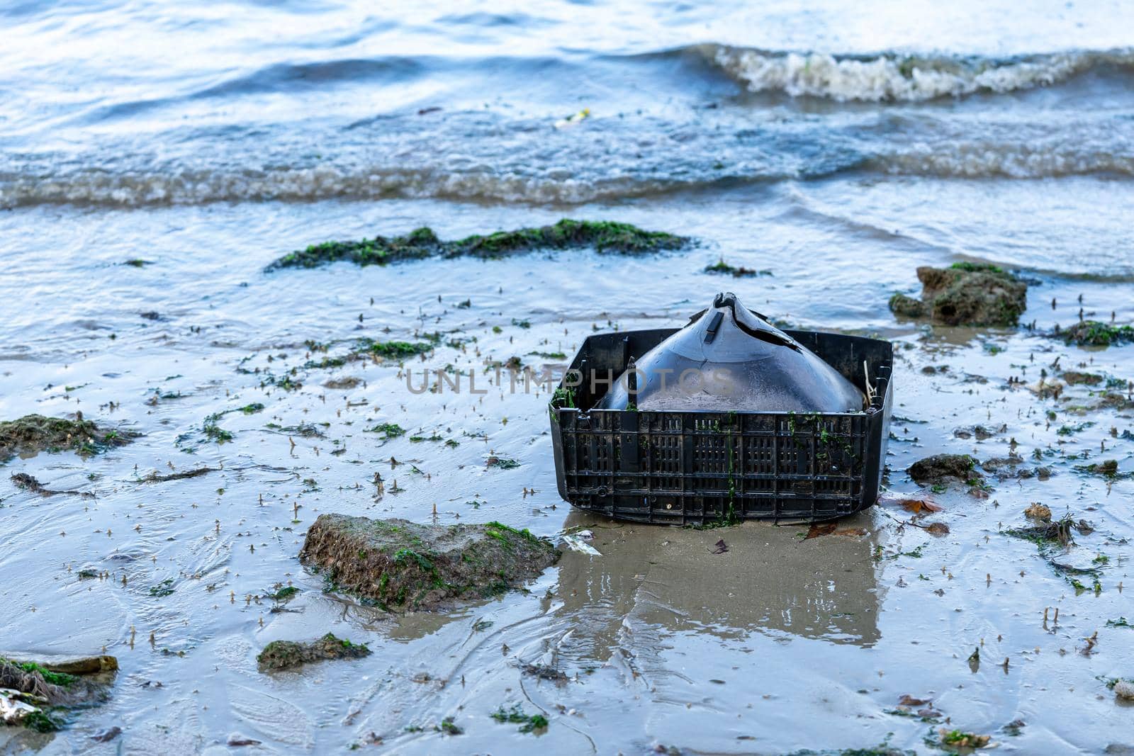 old television set found on the beach. trash left by tourists. Trash thrown on the ocean or beach damaging the environment