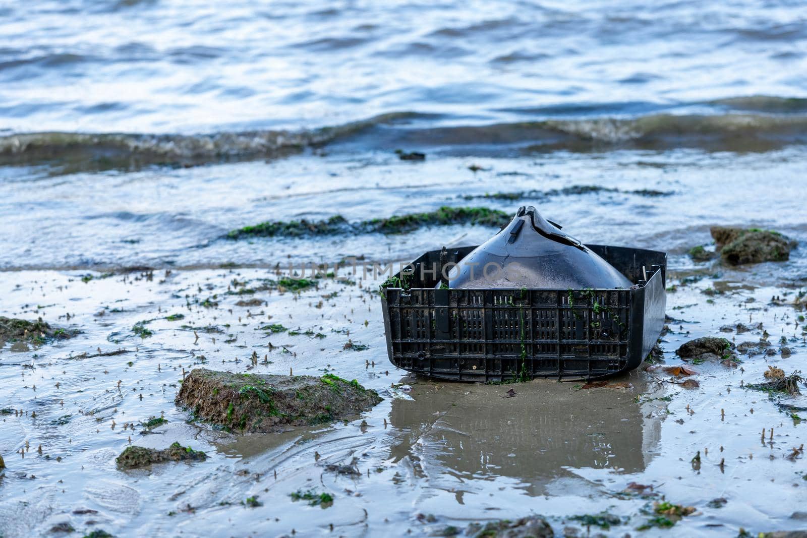 old television set found on the beach. trash left by tourists. Trash thrown on the ocean or beach damaging the environment
