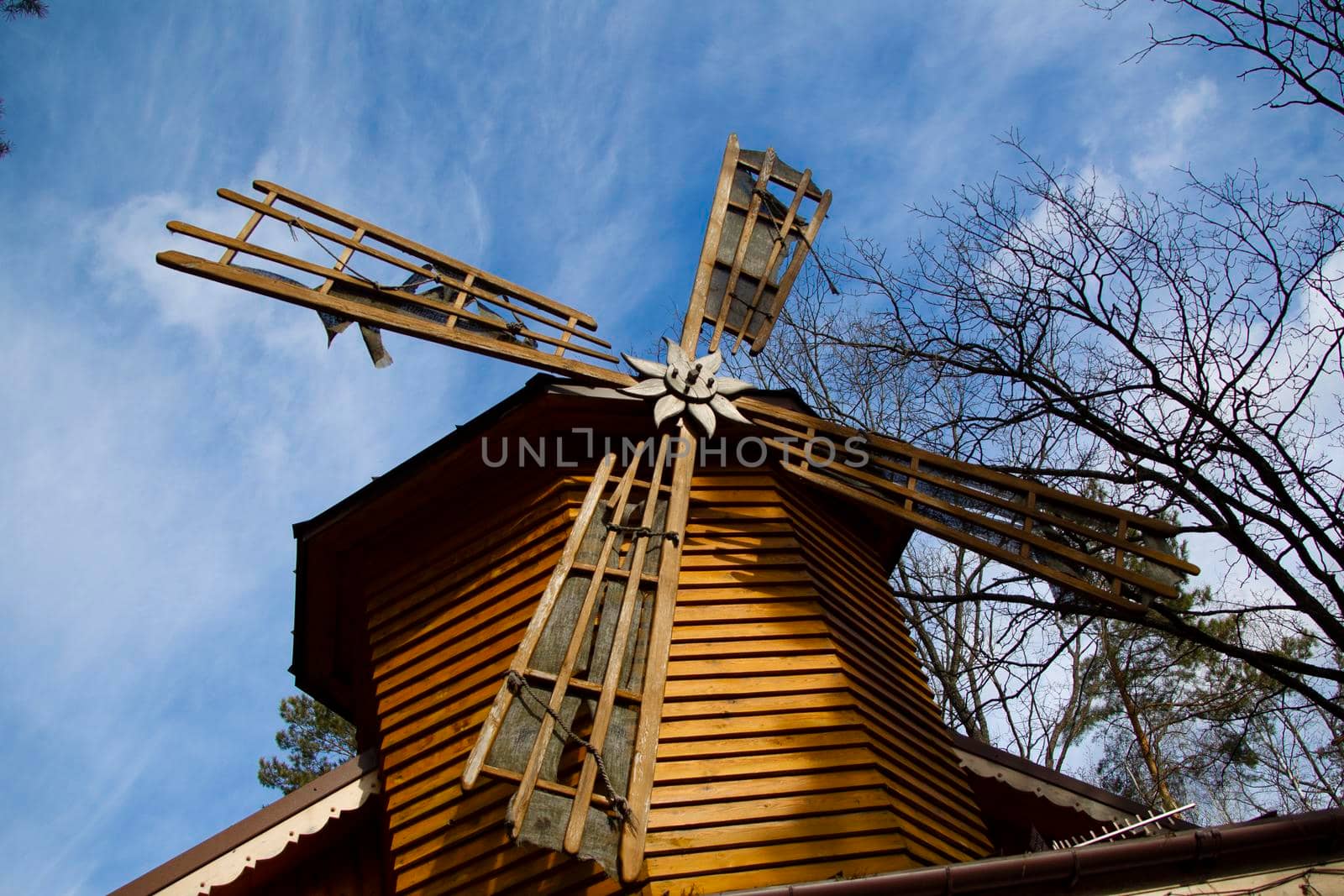 Wooden mill on a background of blue sky.