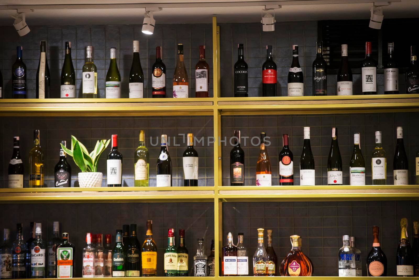 Belarus, the city of Gomil, February 08, 2020. Showcase wine shop. Many bottles of wine stand on a shelf.
