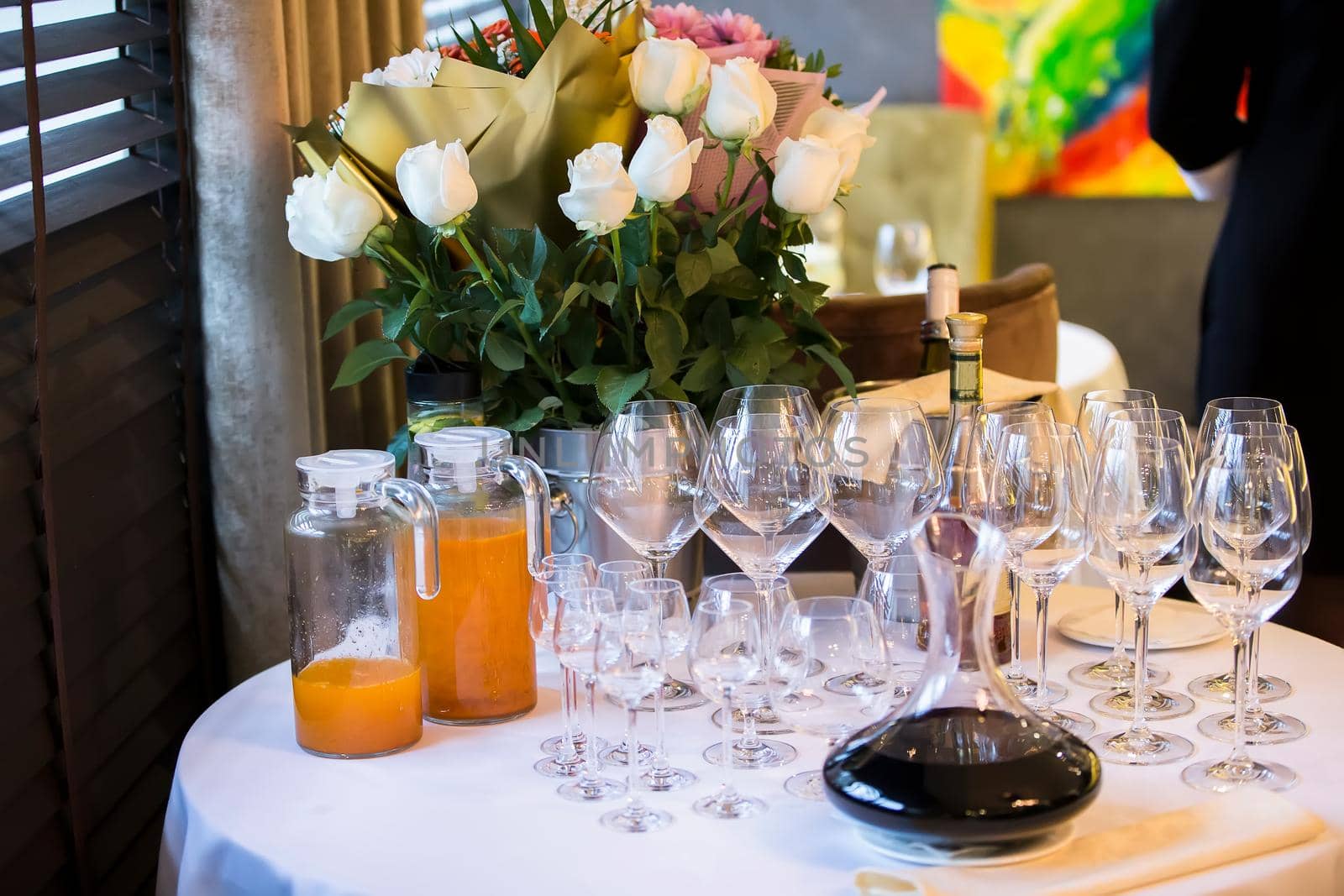 Preparing for the buffet. Restaurant table with glasses and drinks.