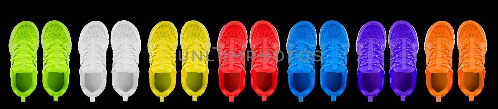 Sneakers in different colors on a black background. Seamless texture of multi-colored shoes.