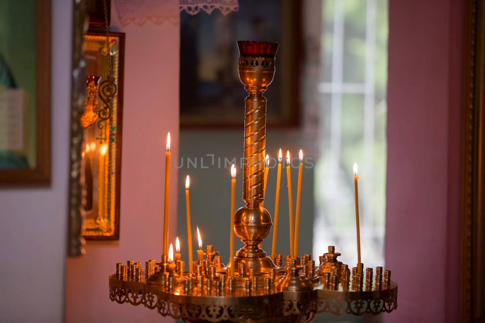 Church candles in a gold candlestick in the temple.