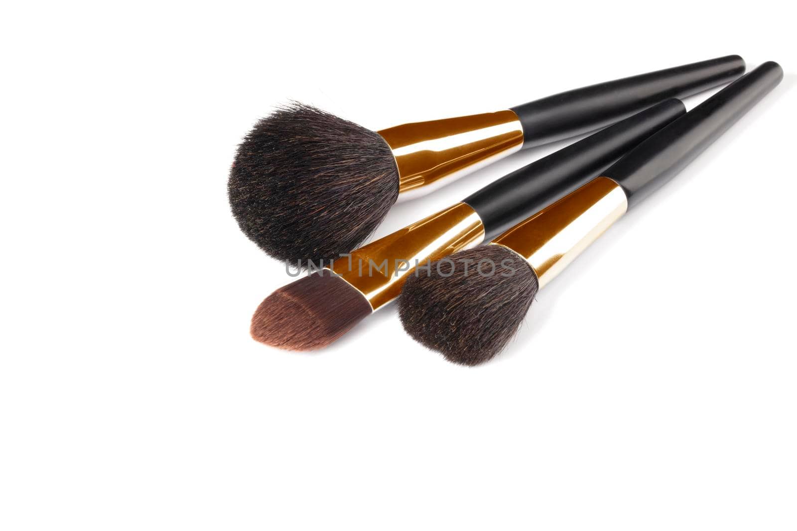 Cosmetic brushes for applying makeup. Makeup artist accessories isolated on white background. Accessories for the perfect make-up of the skin of the face.