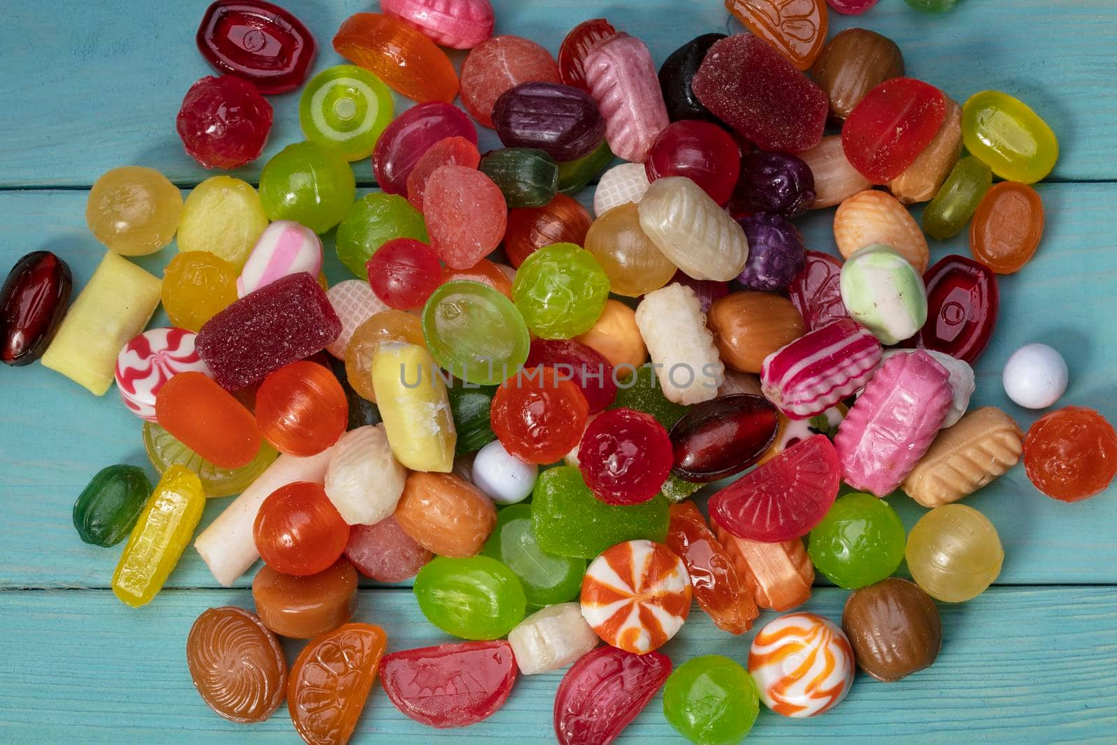 Many sweets. Multi-colored caramel on a wooden board. Sweets.