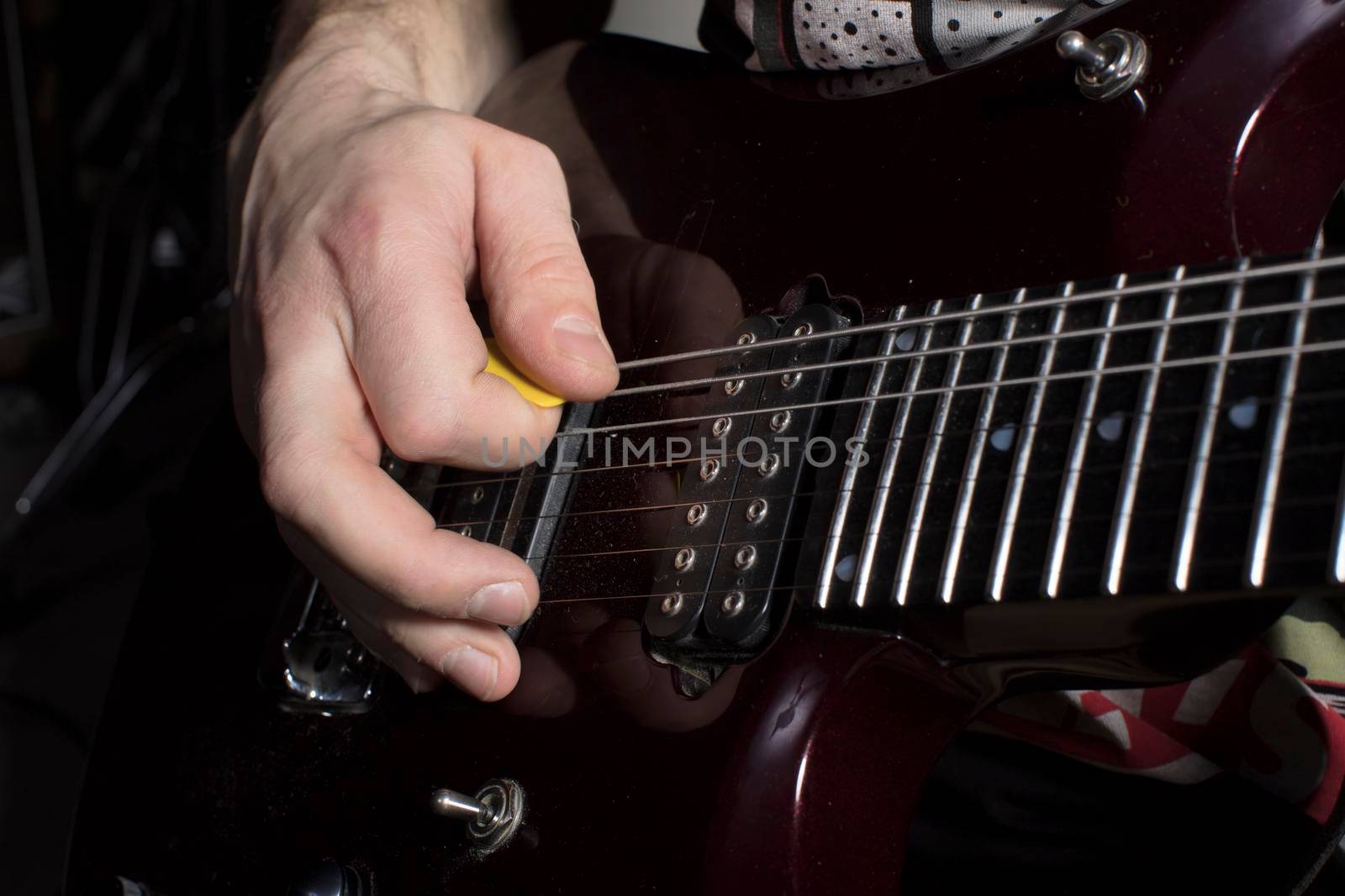 Hand plays the guitar. Iterate over the strings.