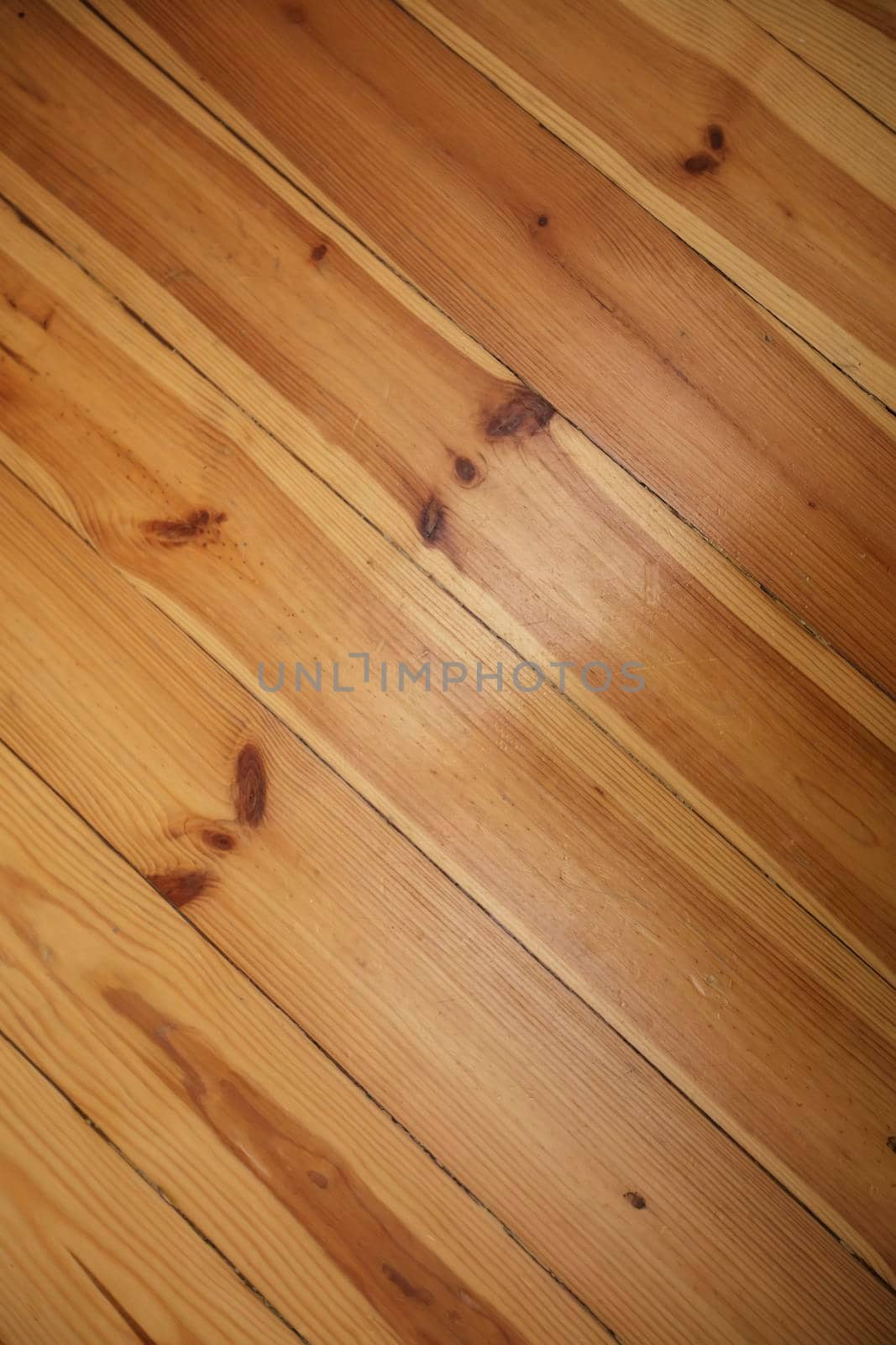 Close-up diagonal texture of a wooden floor.