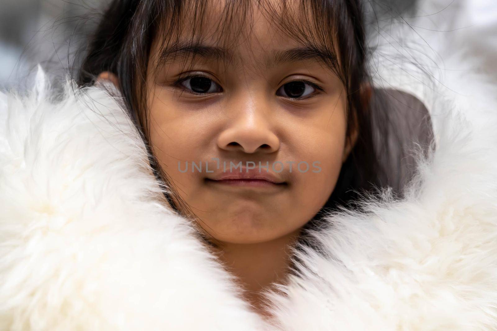 Pretty asian child wearing a white coat made of fur. Pretty asian model wearing white fur coat by billroque