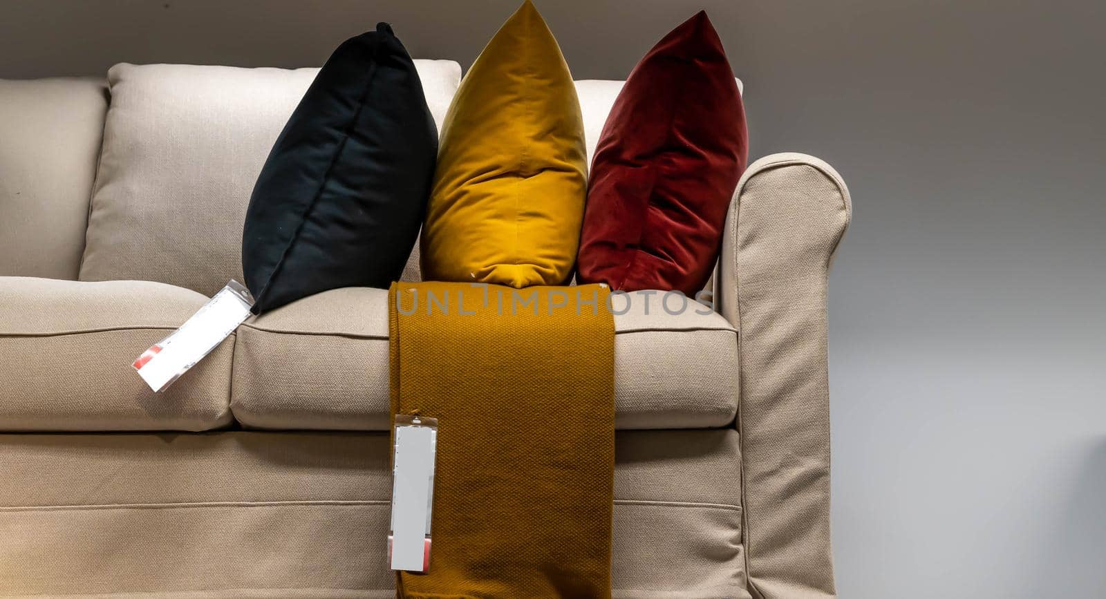 Brown sofa with colorful pillows on sale from a store by billroque