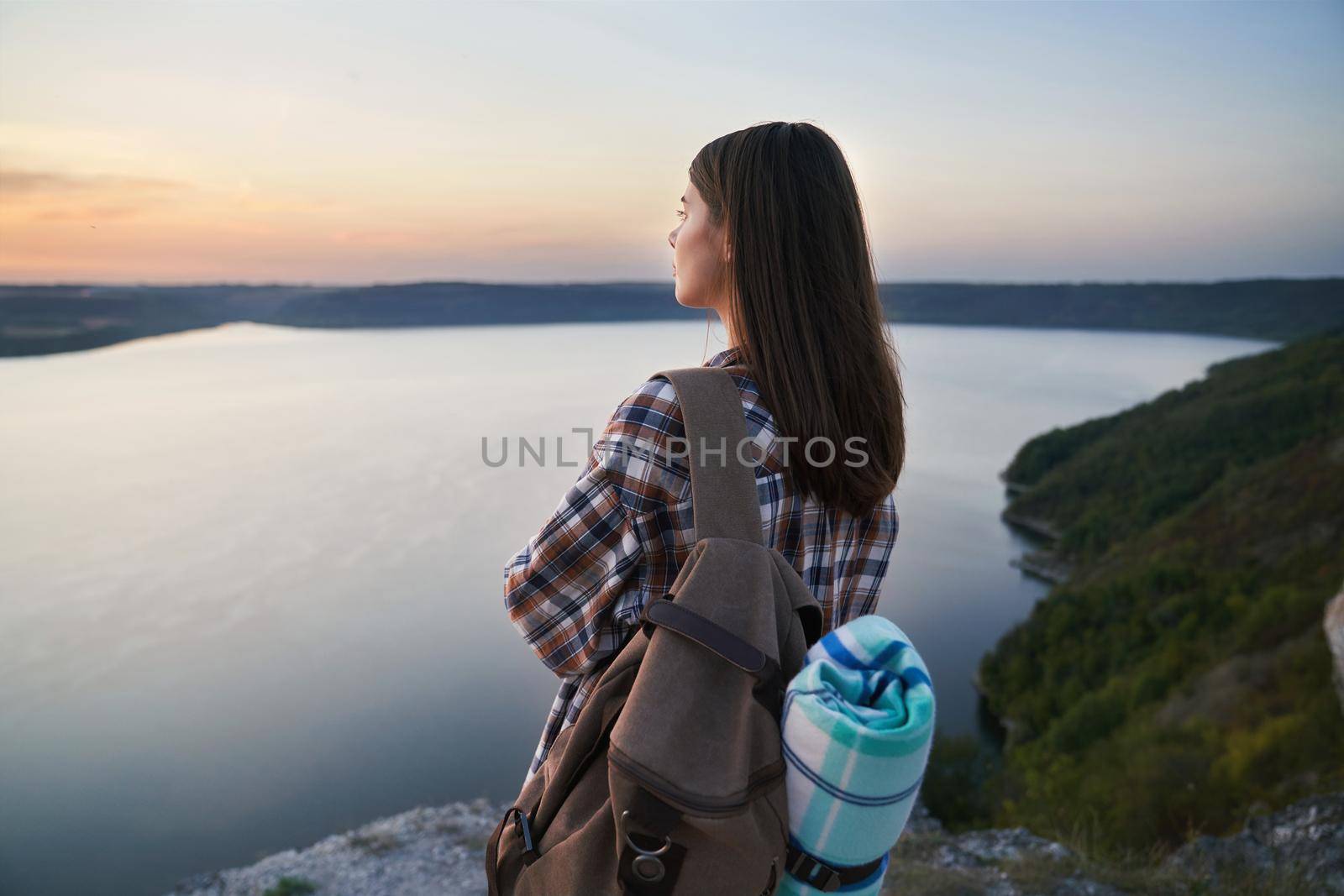 Adorable woman enjoying sunset at Bakota bay by SerhiiBobyk