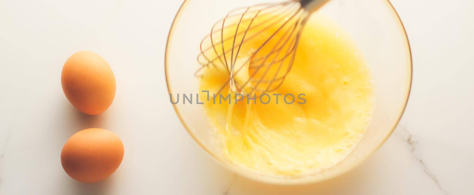 Cooking, meal and diet concept - Making of mixing eggs in bowl on marble table as homemade food flat lay, top view food brand photography flatlay and recipe for cooking blog, menu or cookbook design