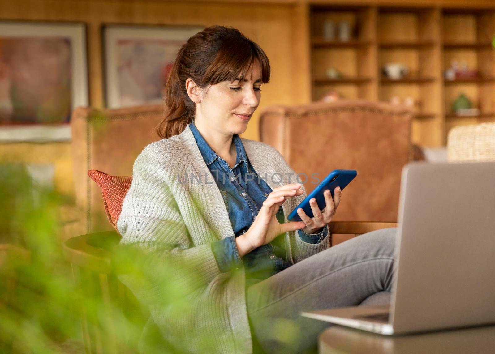 Woman working on a laptop on a cozy space