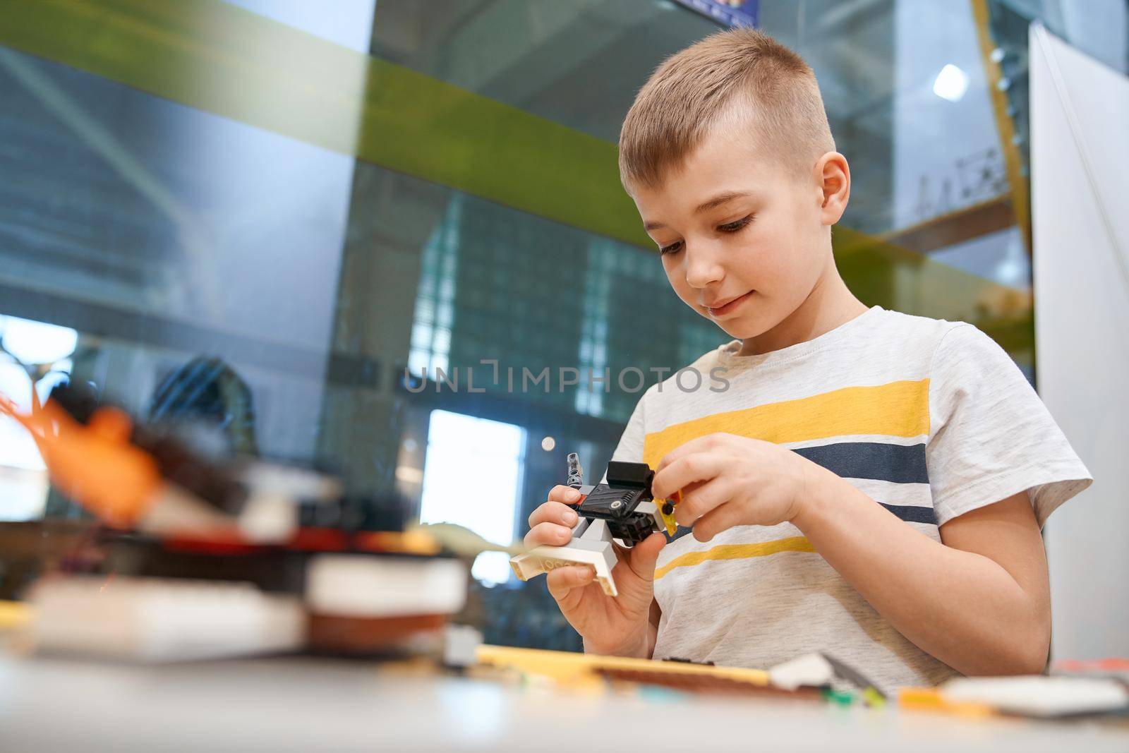 Caucasian boy using building kit. by SerhiiBobyk