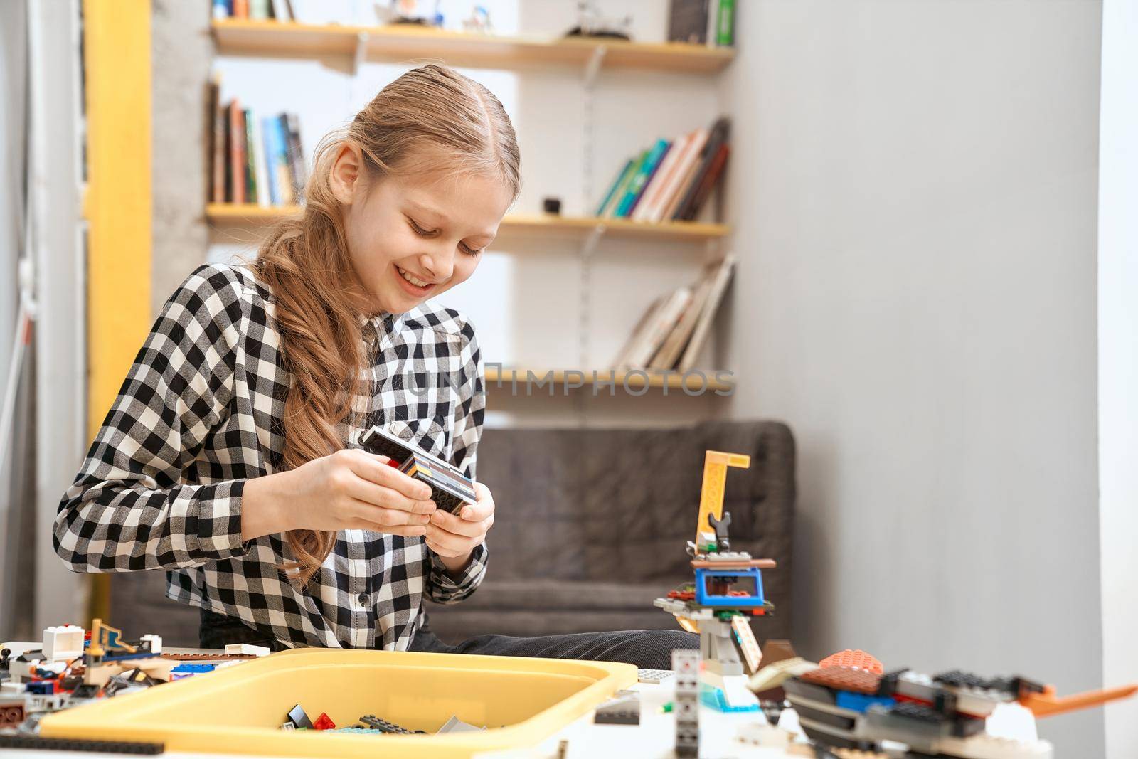 Caucasian girl using building kit. by SerhiiBobyk