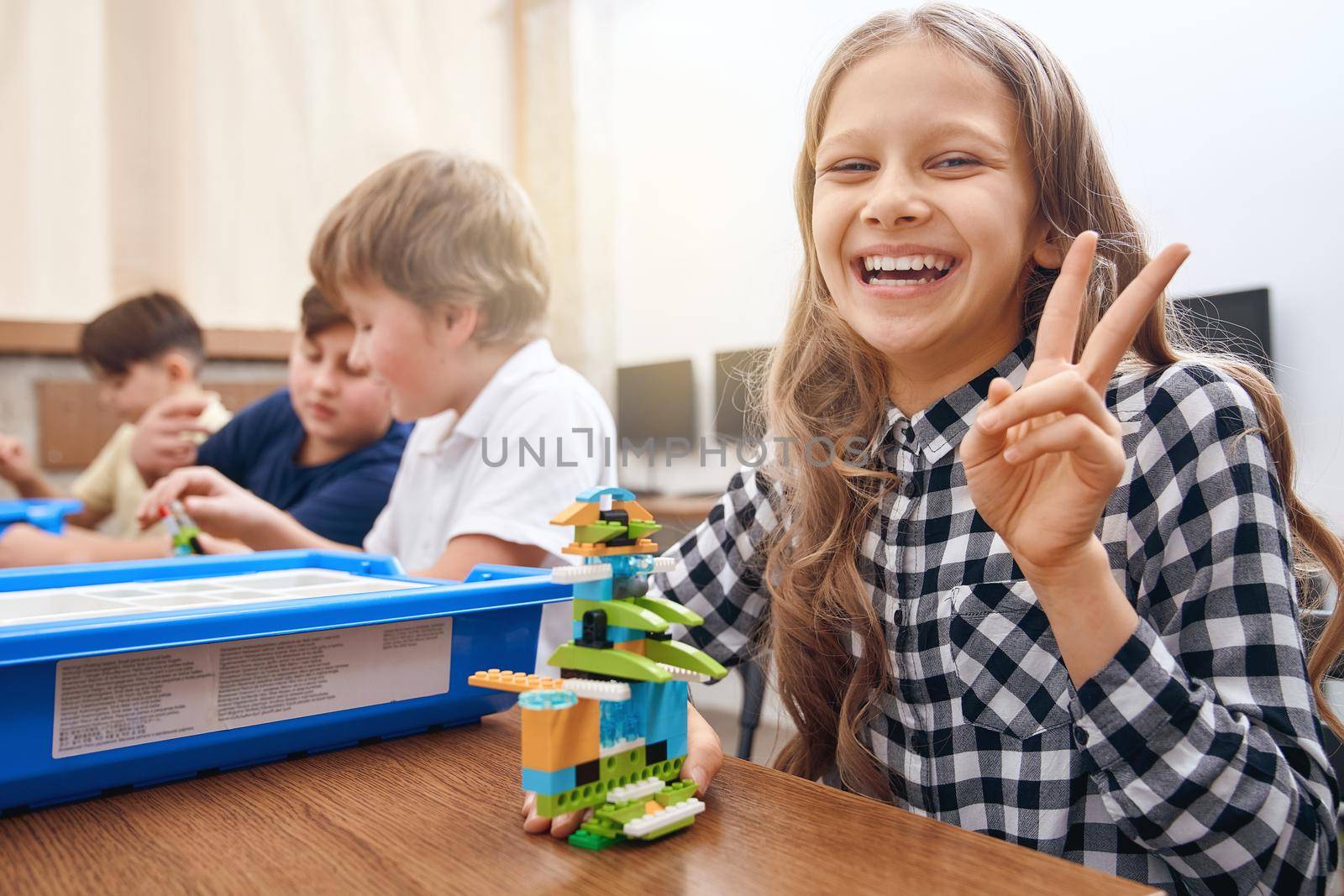 Caucasian girl using building kit. by SerhiiBobyk