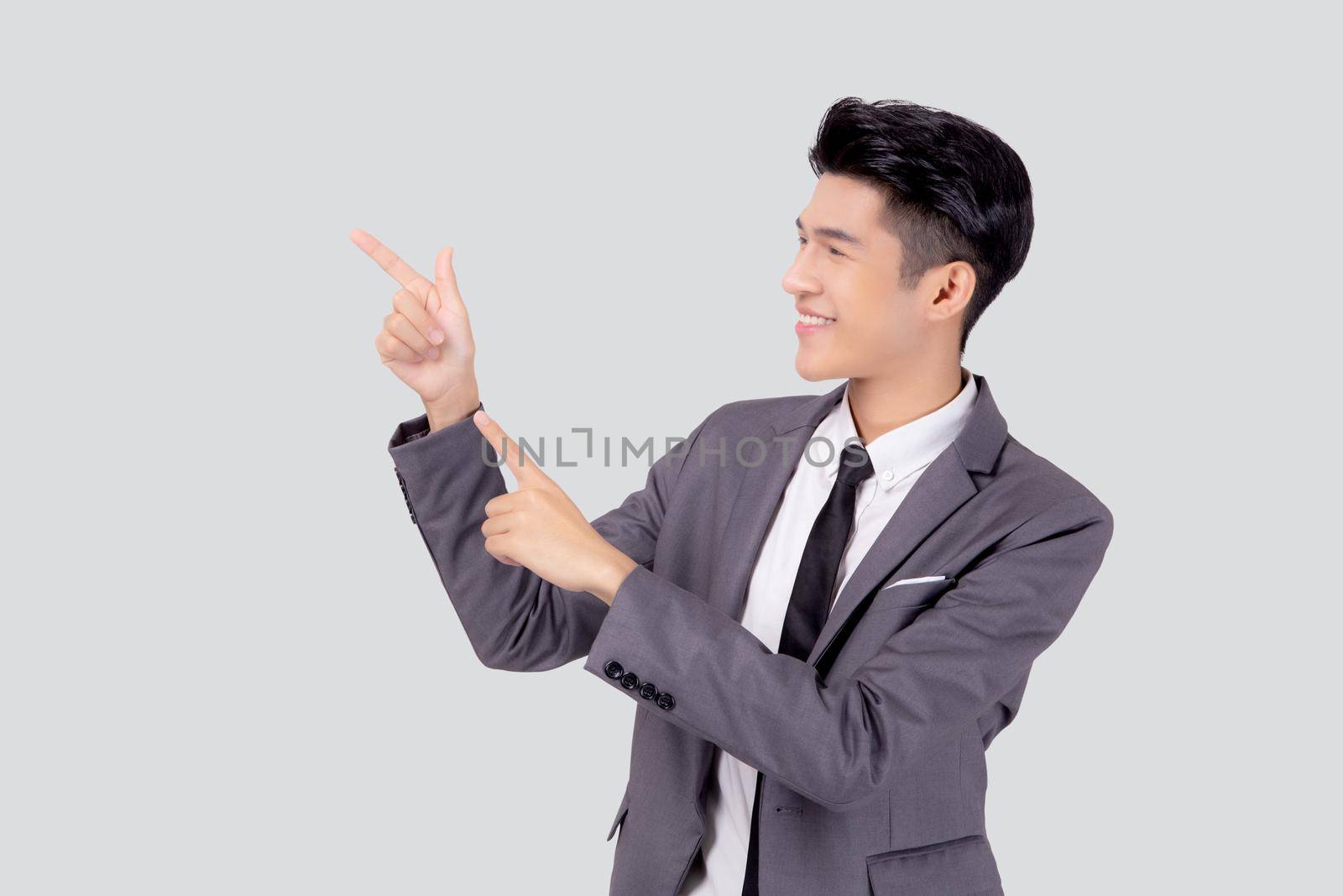 Portrait young asian business man pointing and presenting isolated on white background, advertising and marketing, executive and manager, male confident showing success, expression and emotion.