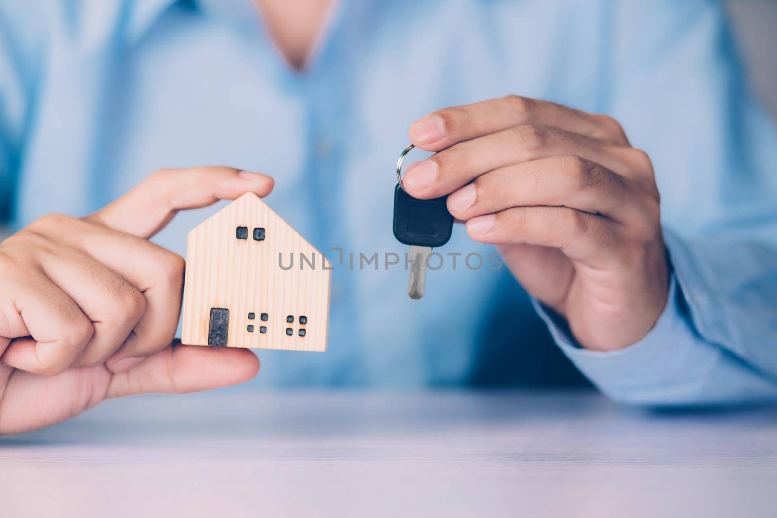 Hand of businessman is agent holding key house, insurance home and real estate for investment, residential and agreement with approval, loan, debt and financial, business and property concept.