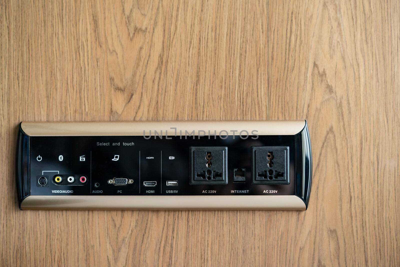 Electrical wall socket adapter, plug power outlet and USB charger socket on the wooden wall.