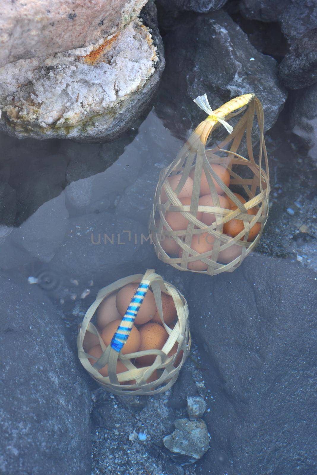 boiling a basket of eggs inside hot spring park