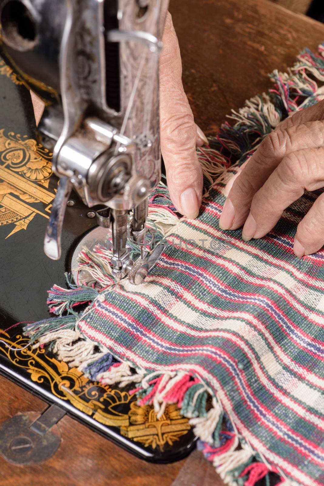 Tailor working on a vintage sewing machine