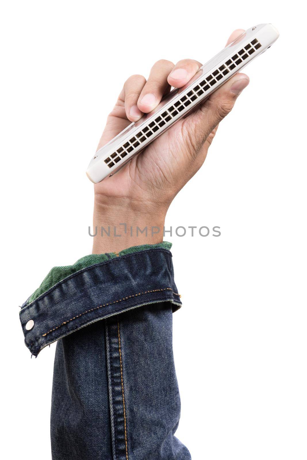 isolate harmonica in musician hand over white background