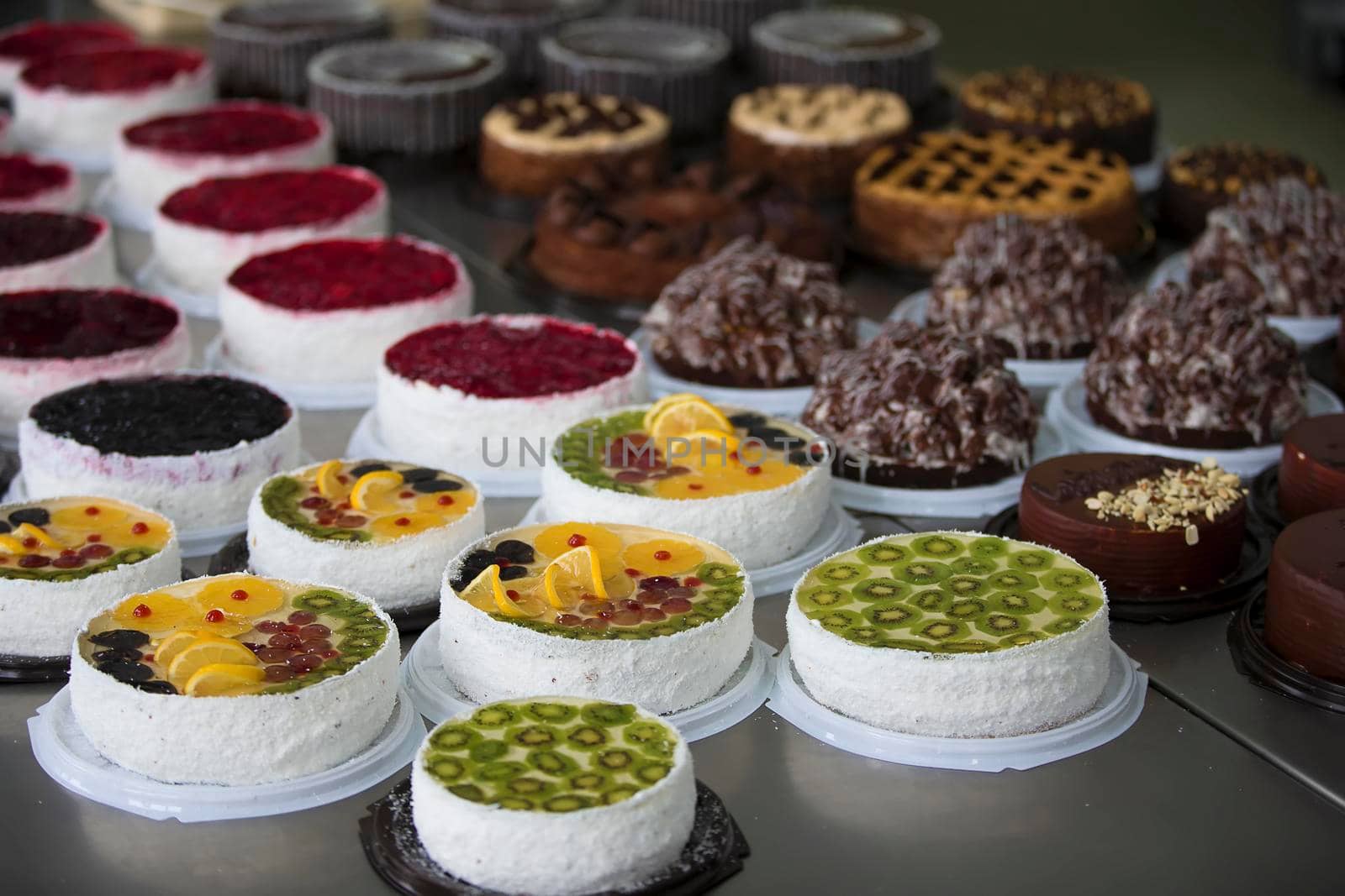 Cake and baking line.Industrial line of cakes. Many beautiful cakes on the table.Multicolored culinary products