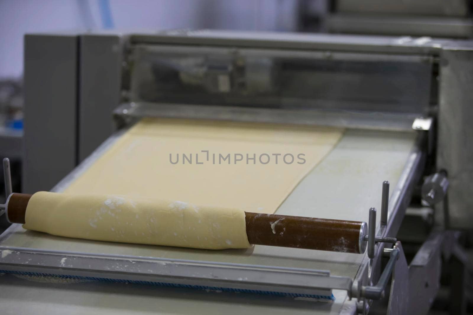 Industrial production of culinary products and bread.Yeast dough on the bread baking line