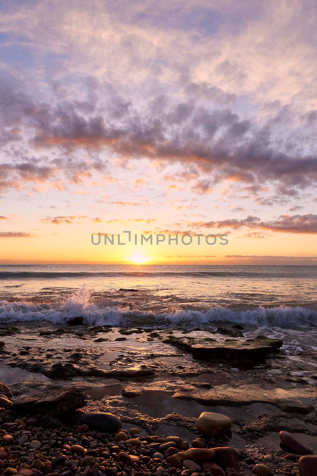 Sunrise on the rocky beach by raul_ruiz