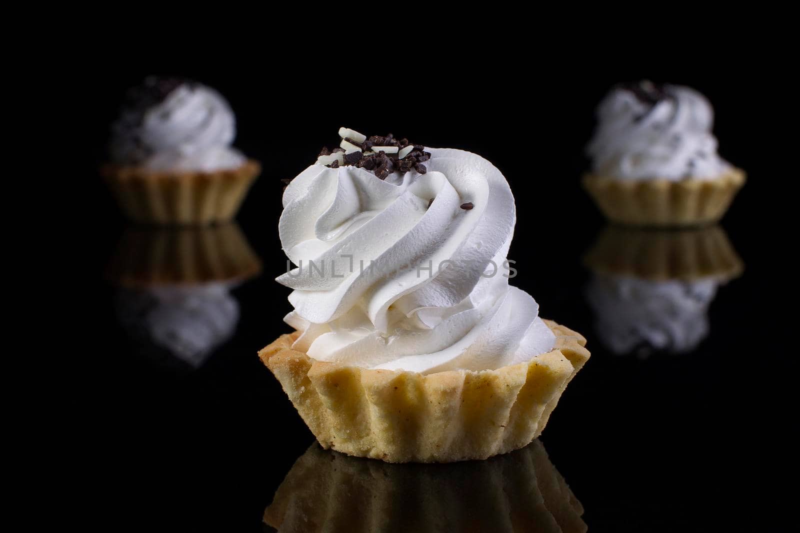 Cake with protein cream on a black background.Cake Baskets