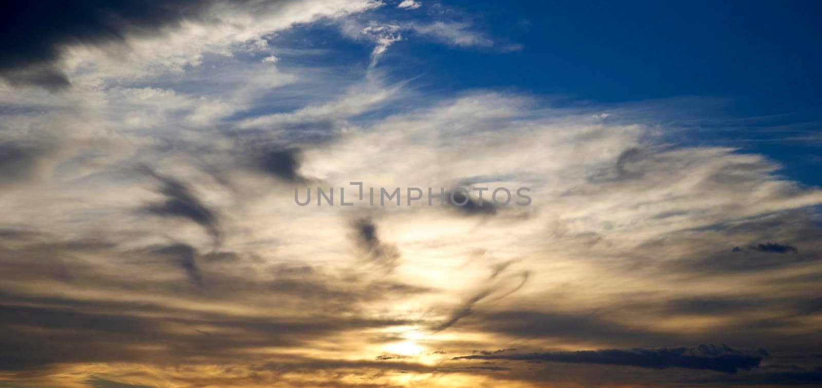Sky full of clouds of different colors in a sunset by raul_ruiz