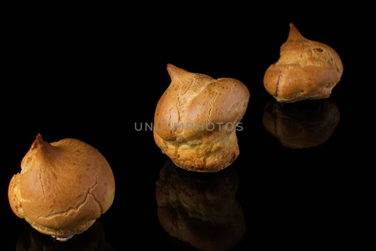 Cake profitroles close-up on a dark background