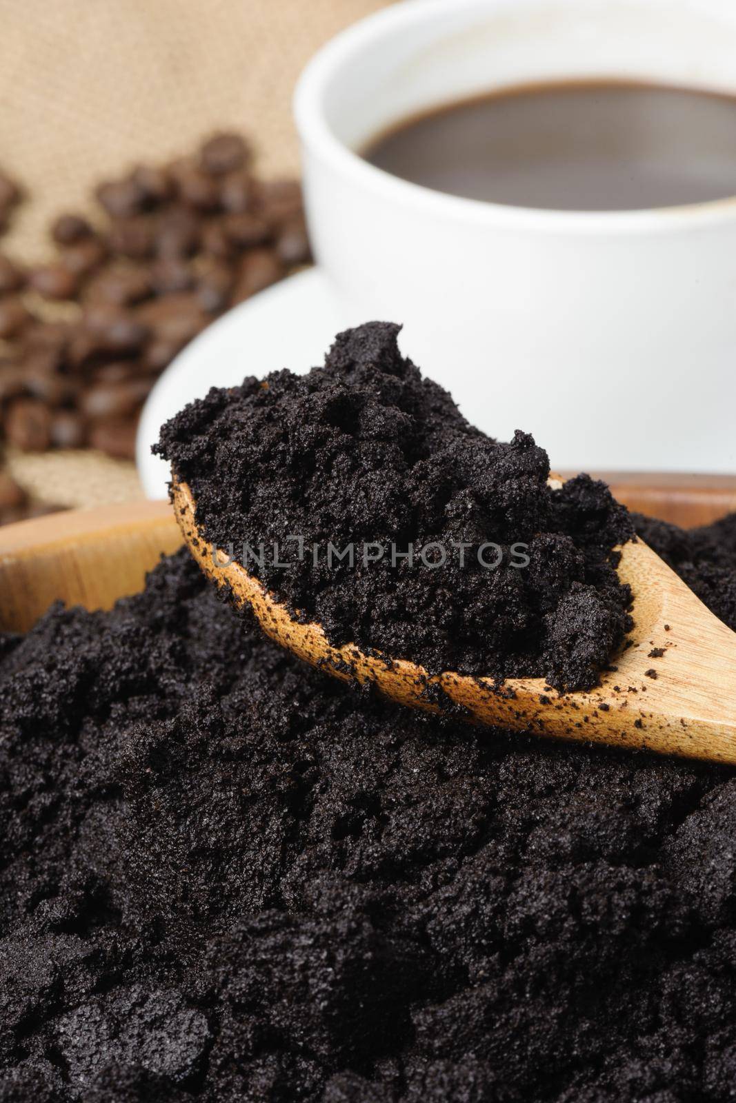 closeup detail of coffee ground in wooden spoon