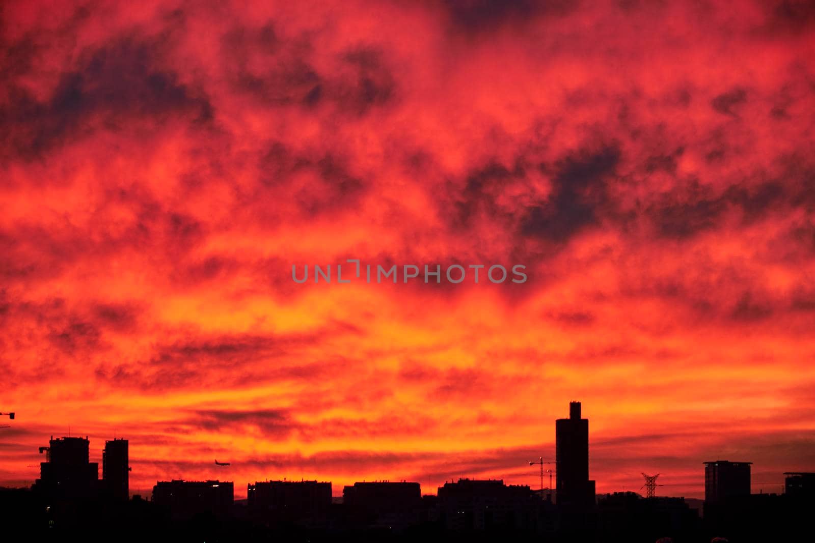 City Skyline at Sunset. Airplane reddish sky, free space