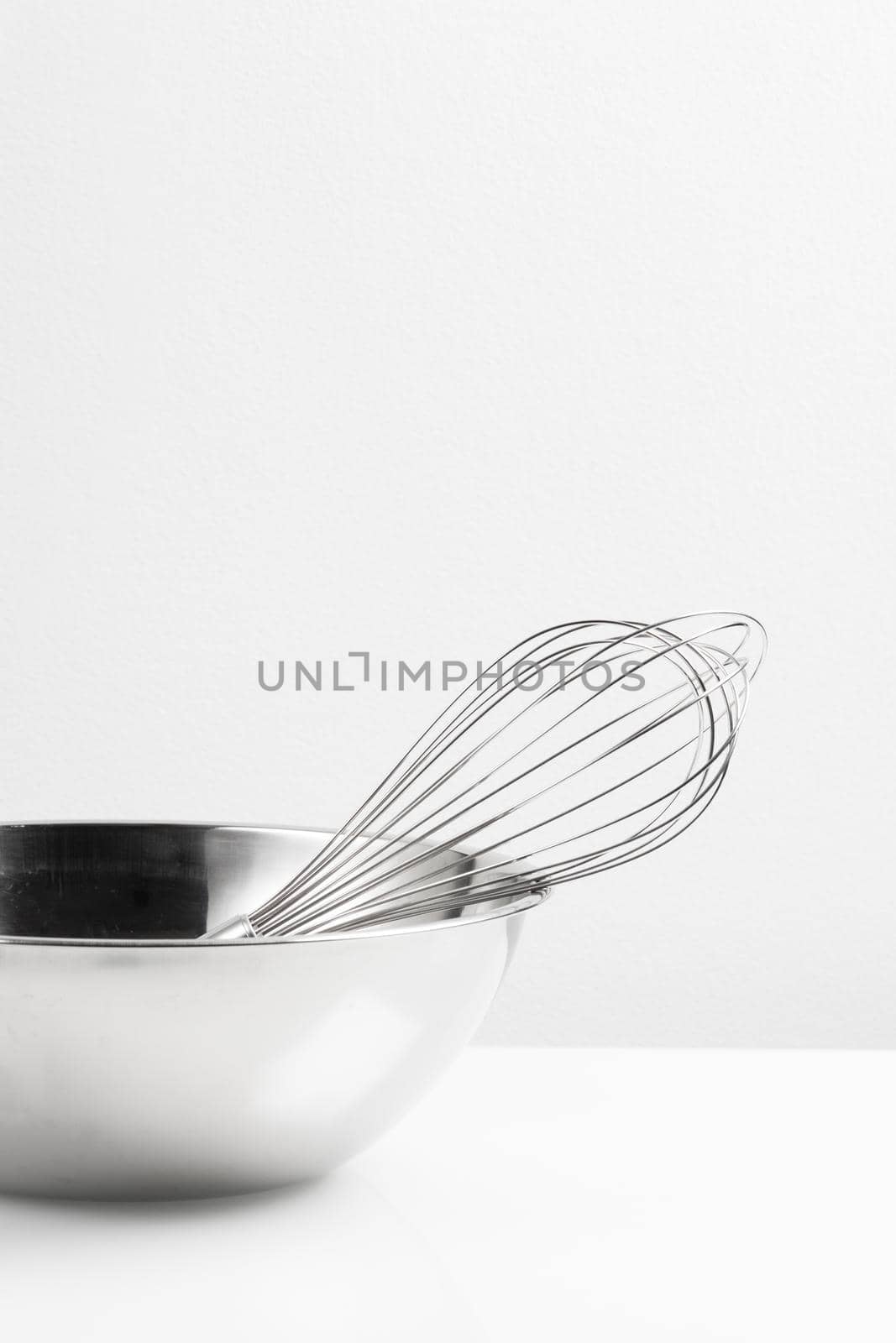 isolated stainless Whisk and stainless bowl on white background