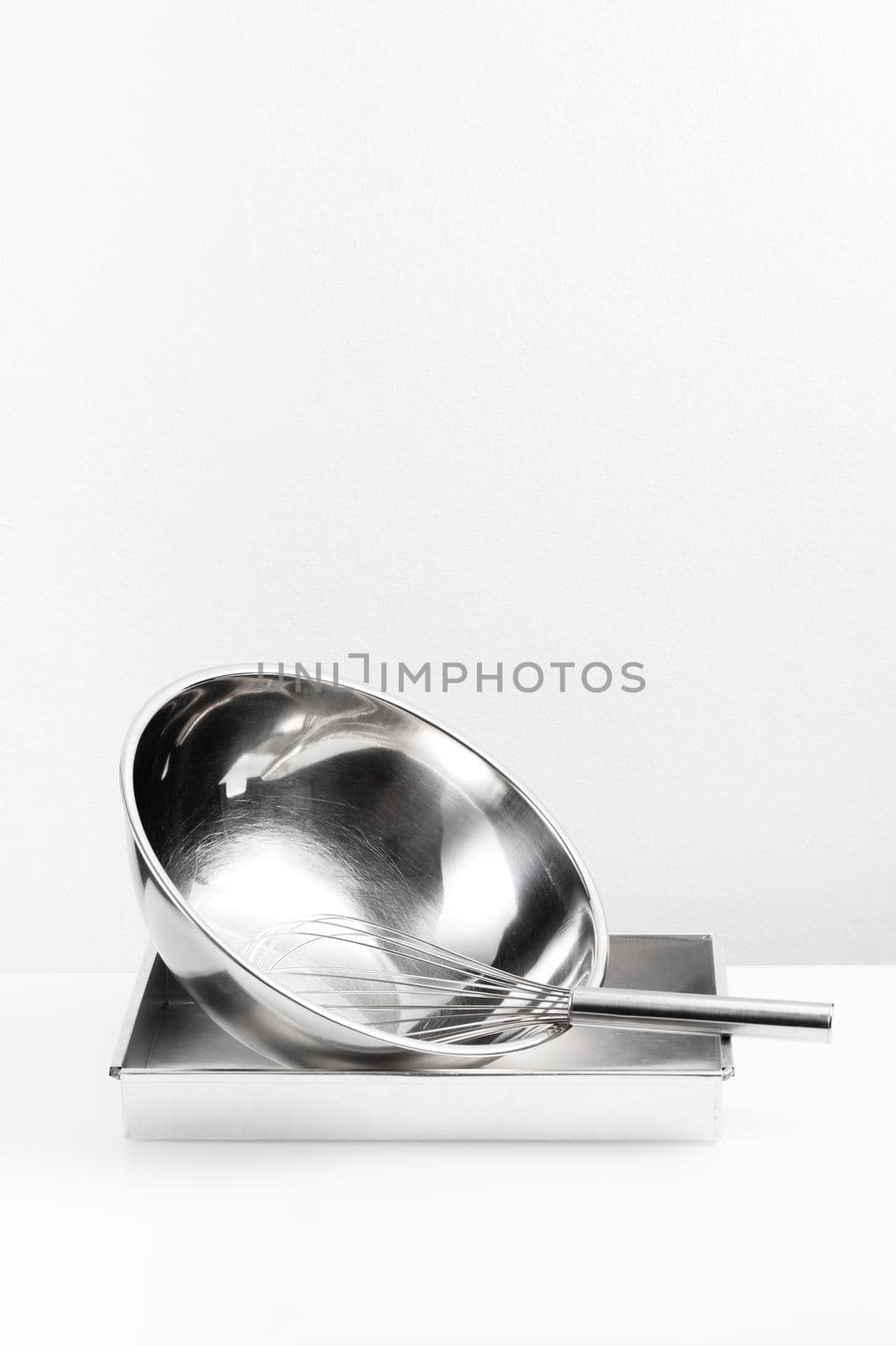 isolated stainless Whisk and stainless bowl on white background