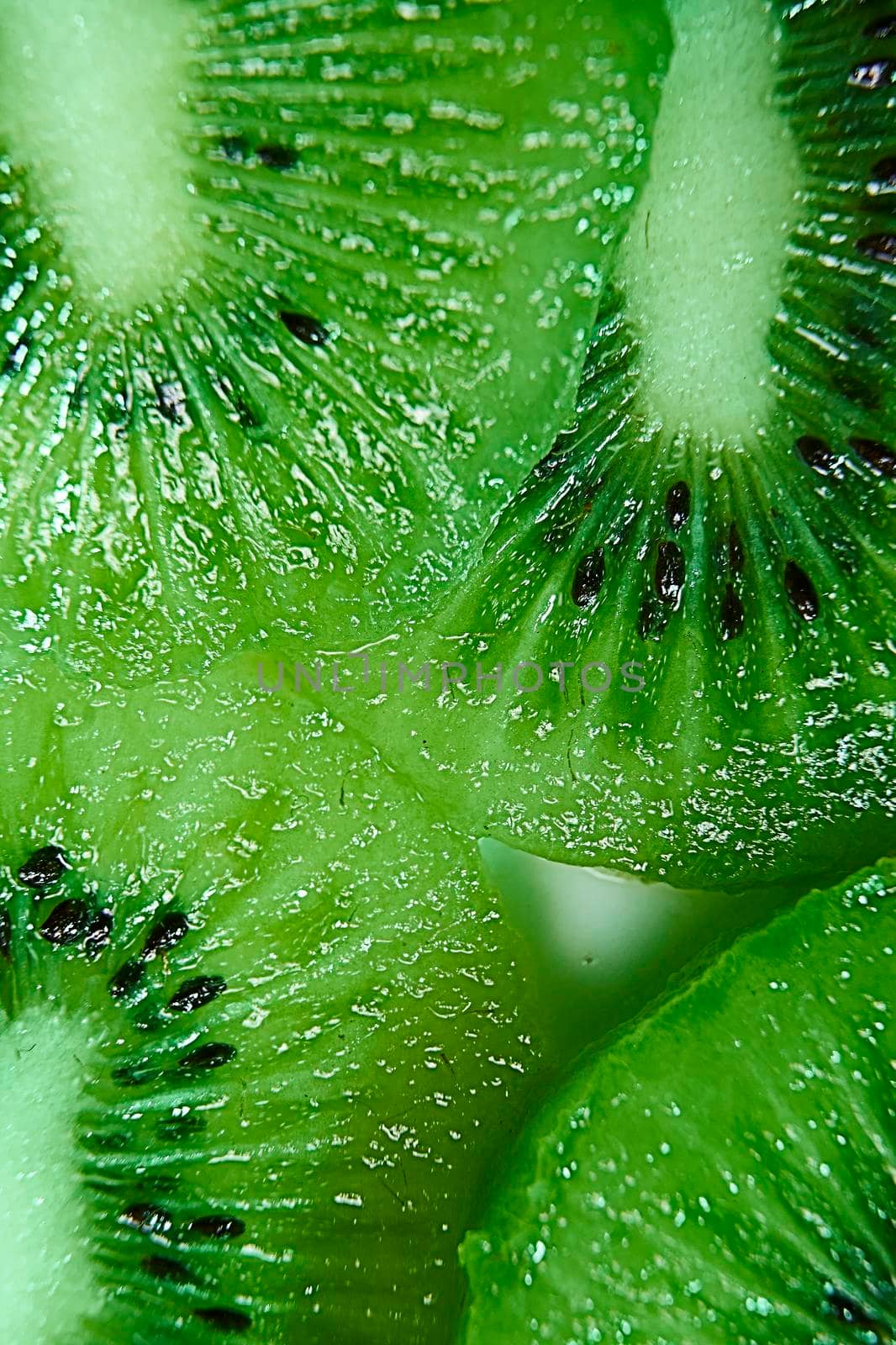 Close-up of several cut kiwis. Green and seeds, macro photography, zenithal