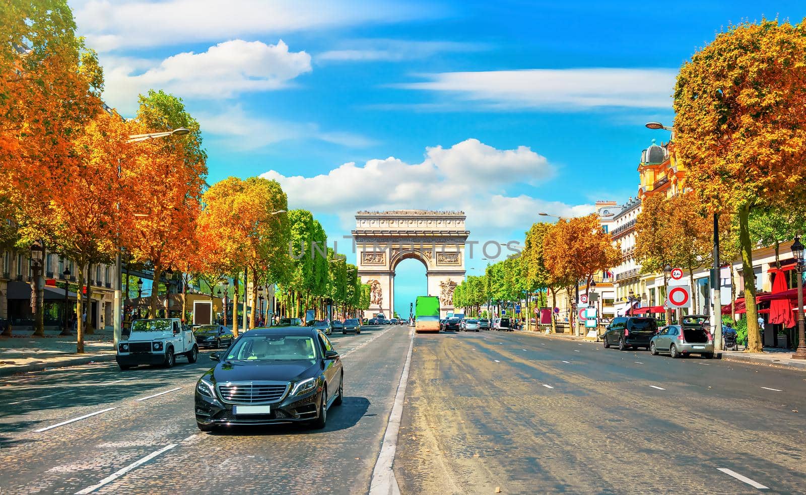 Traffic on Champs Elysee in sunny autumn day