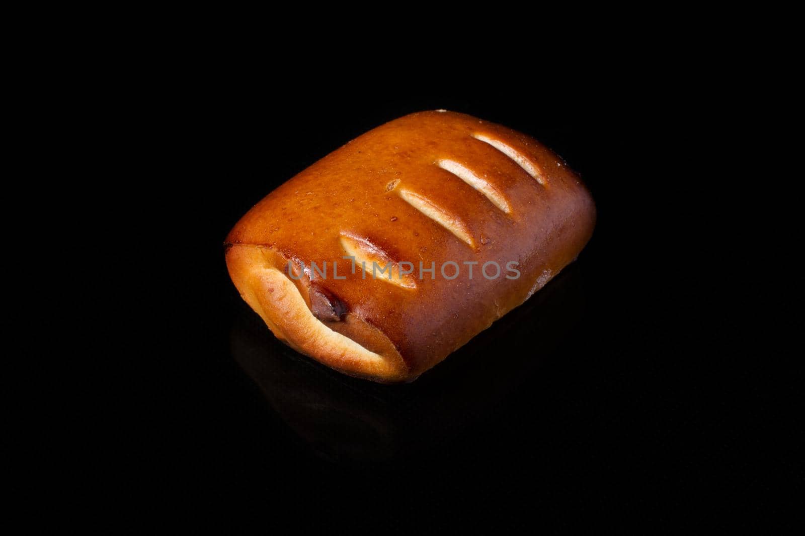 Bun with fruit filling on a dark background
