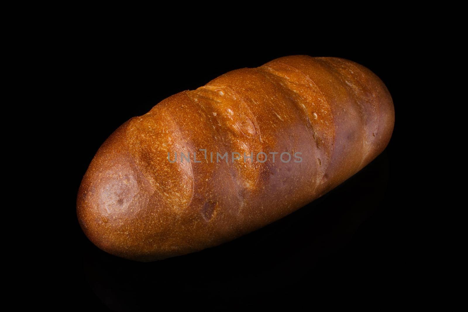 White bread on a black background.Loaf