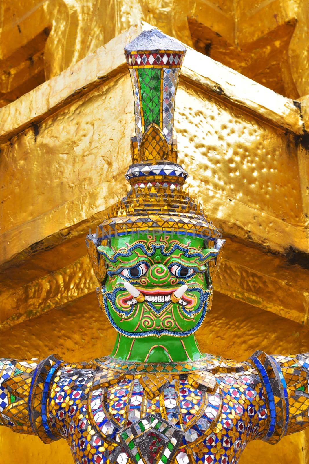 closeup face and headdress of Yak(giant) statue at Wat Phra Kaew in Bangkok, Thailand.