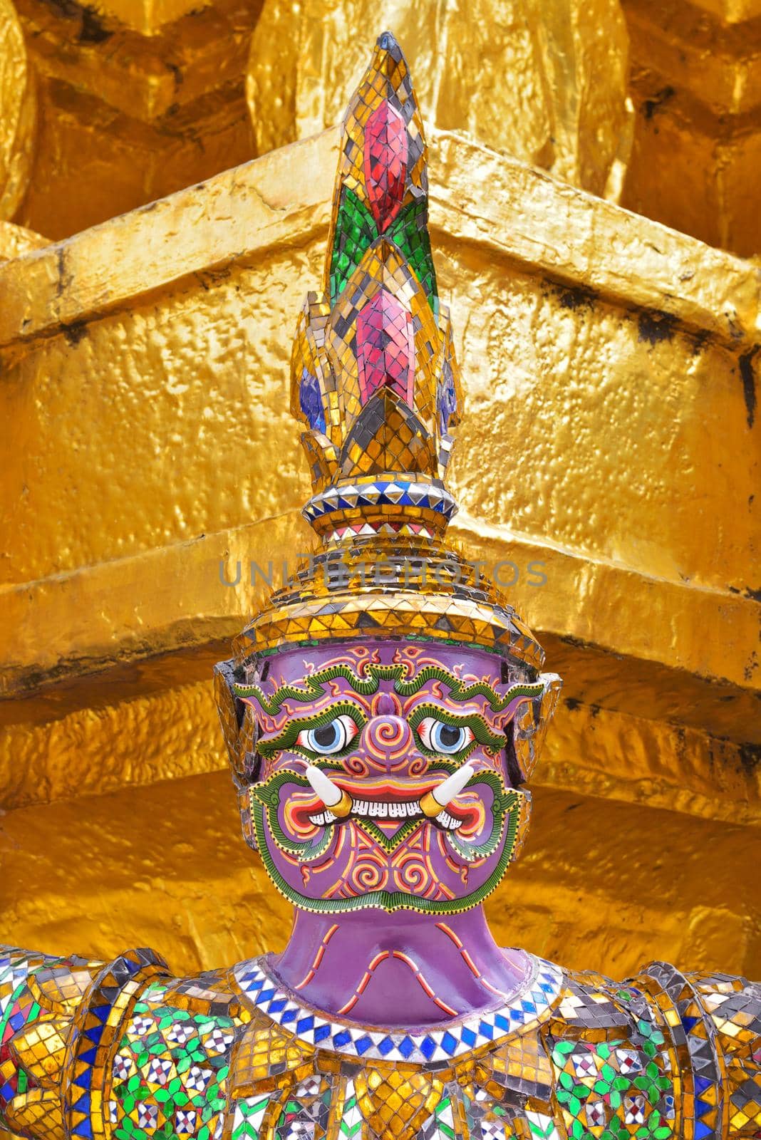 closeup face and headdress of Yak(giant) statue at Wat Phra Kaew in Bangkok, Thailand.